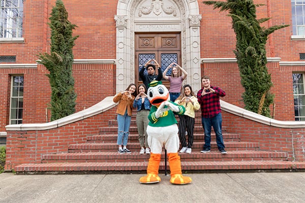 Duck and students throwing 