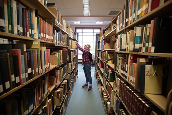 Student looking for book in library