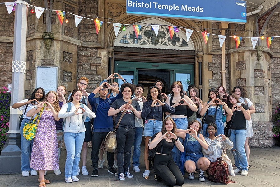 A group of UO students shooting the “O” while standing in front of a railway station in Bristol, England