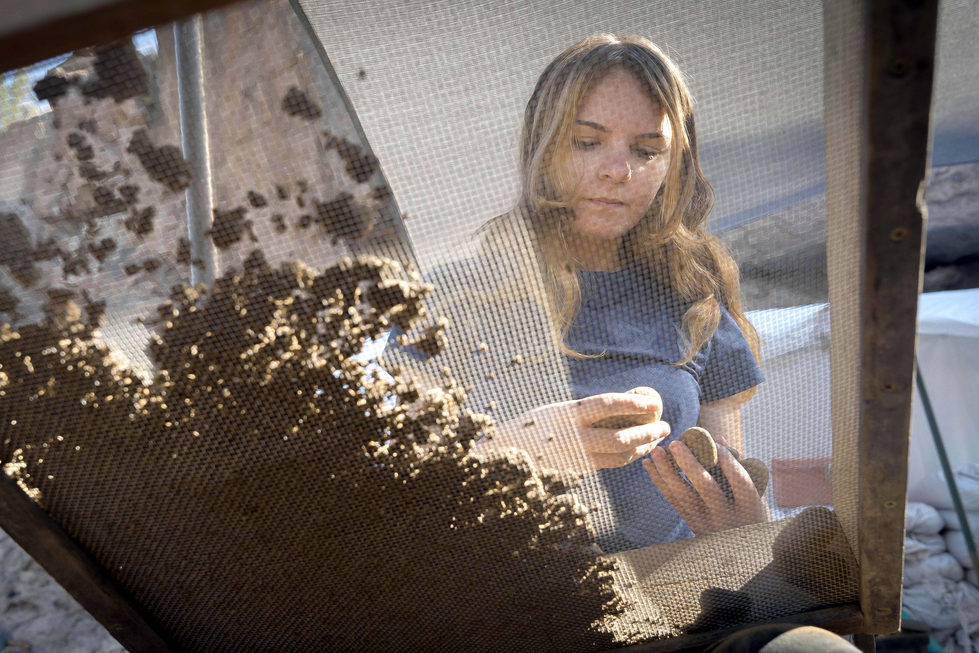 Gabi Gauthier holding stones above a screen