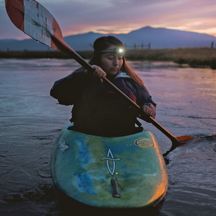Ashia Wilson in water kayaking at twilight