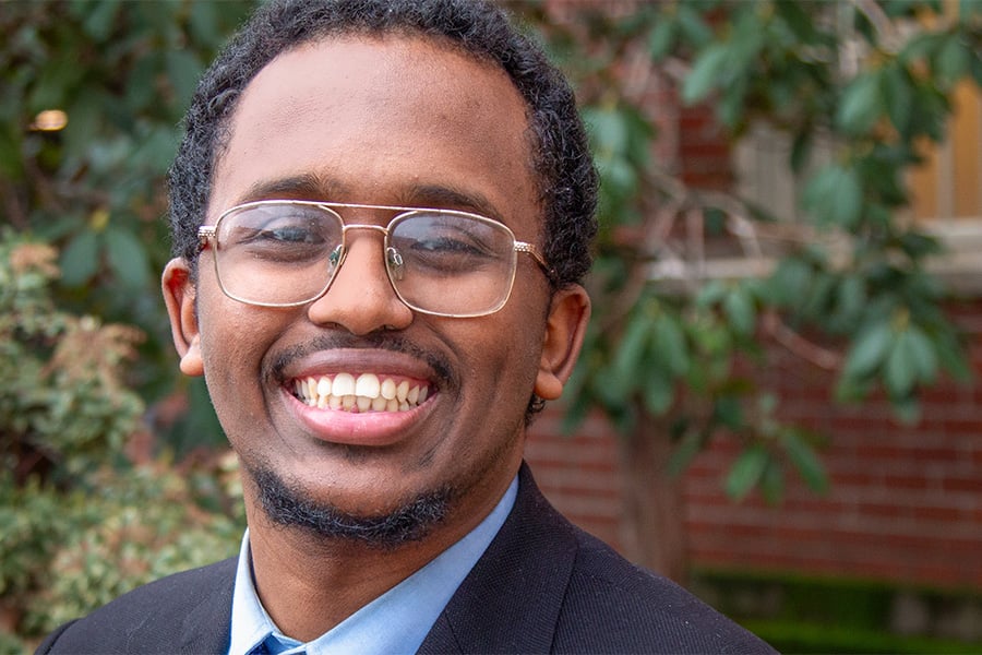 Abdirahim Mohamoud in black suit jacket and blue button down
