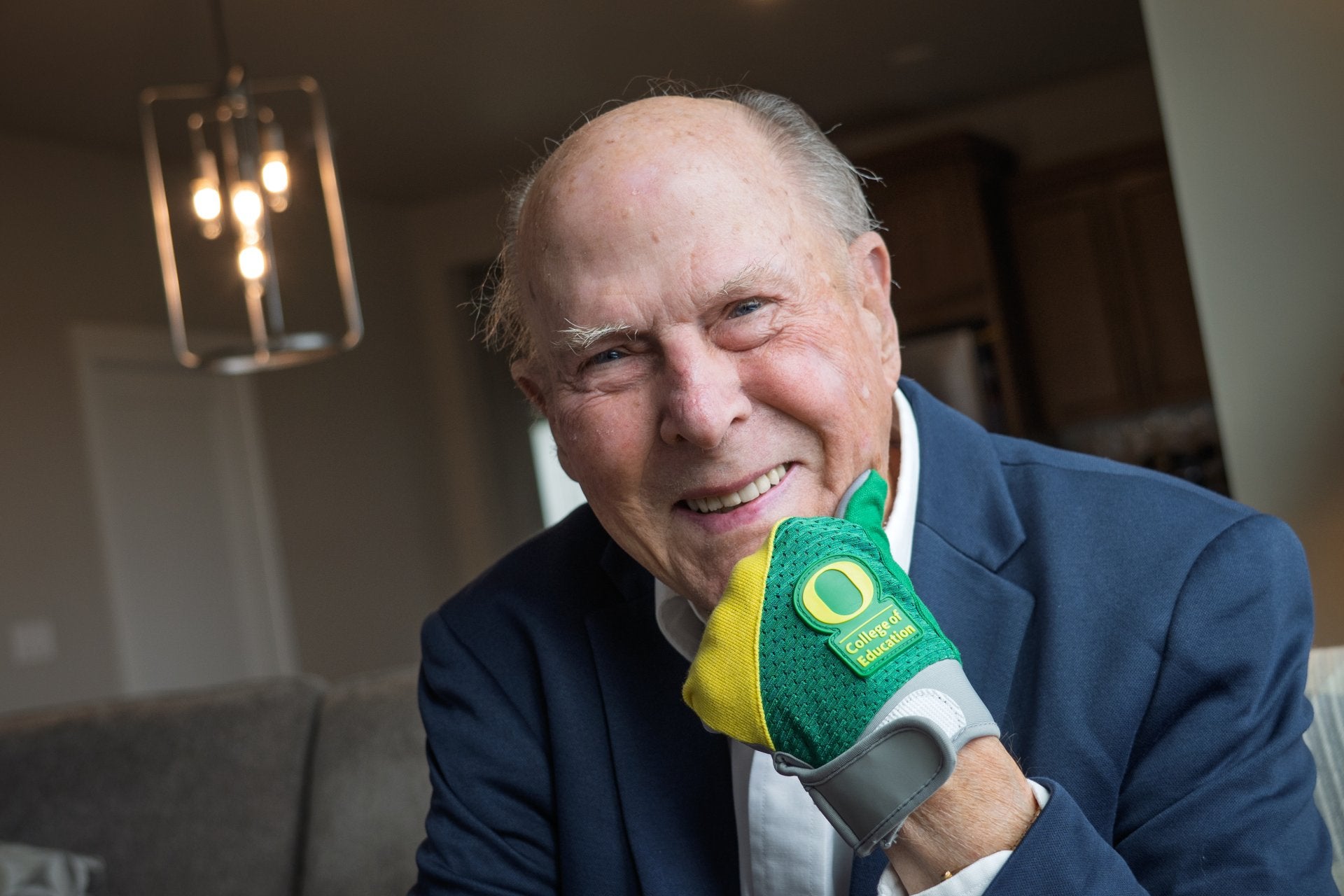 Alan Eliason poses with a UO-themed glove on his left hand. 