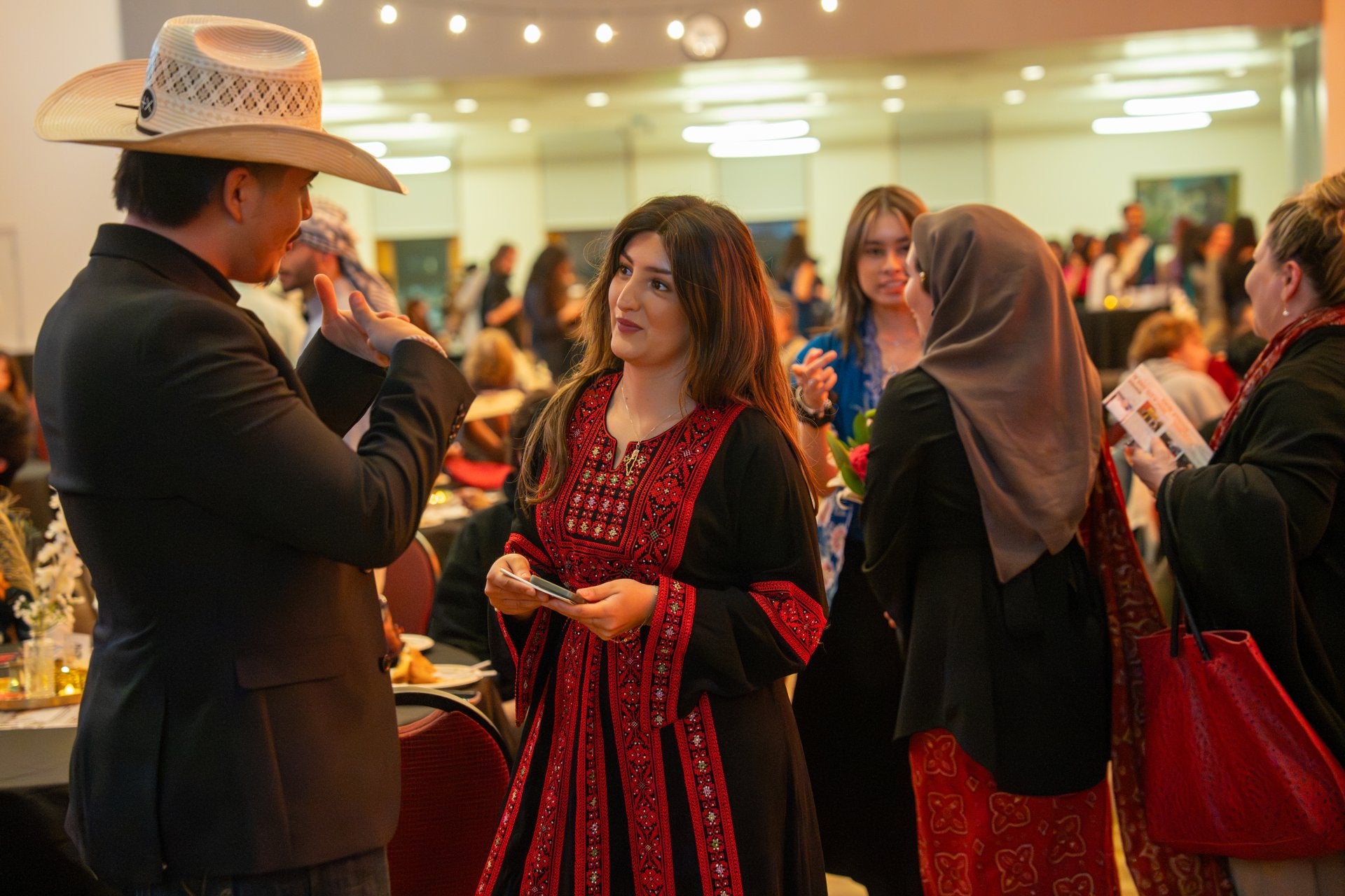 Sophia Barghouti at a social event talking to another person