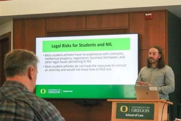 Presenter giving presentation on NIL deals