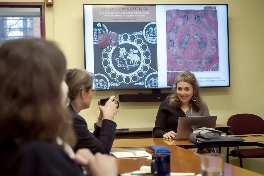 Woman giving a presentation around a table