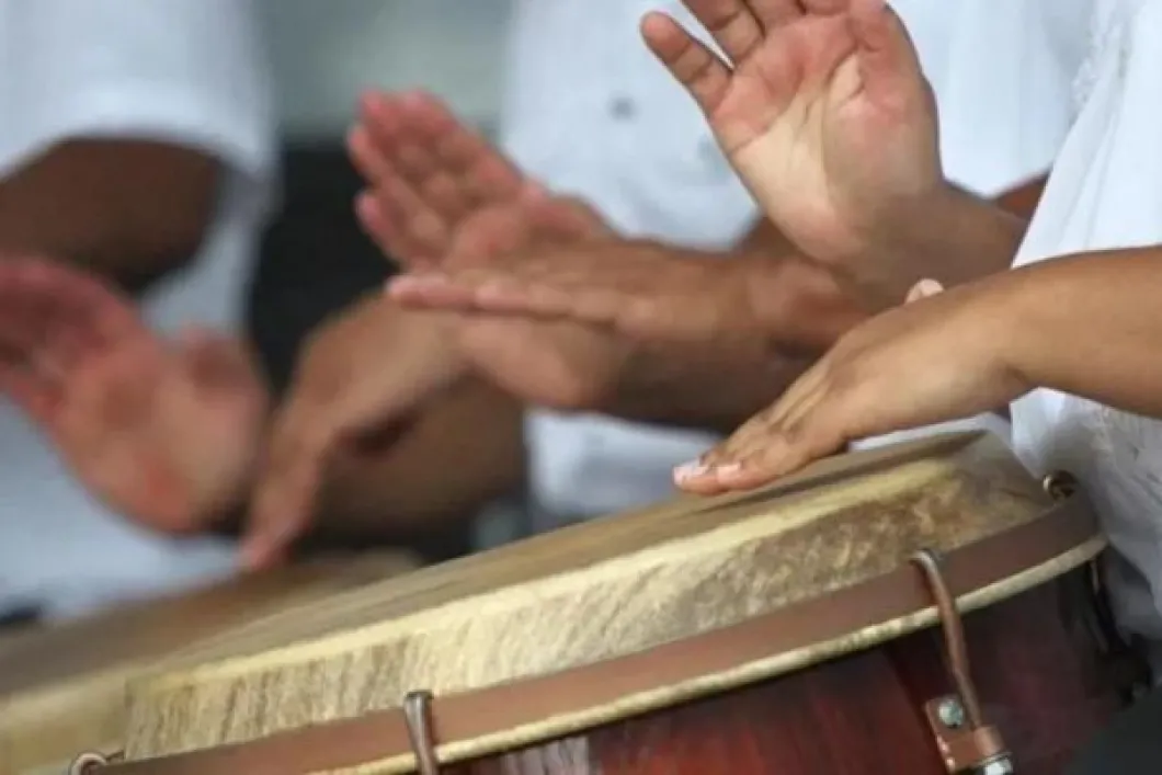 Hands playing Puerto Rican folk music on a typical Latin drums