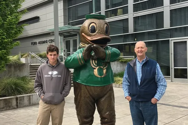Casey and Phil Estes next to bronze Duck statue