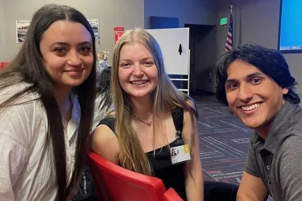 Three human physiology student interns smiling at camera