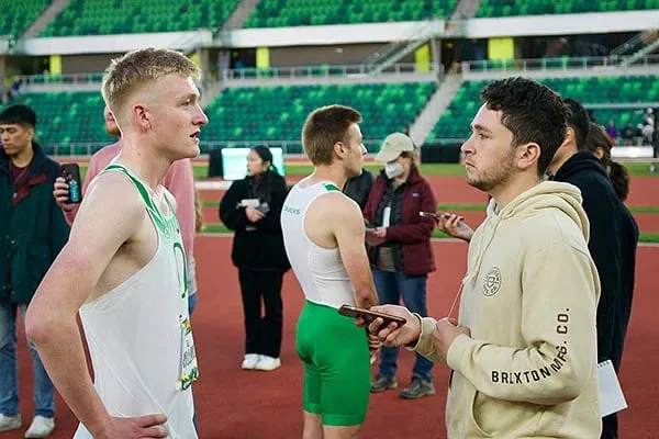 SOJC student interviewing runner at Worlds