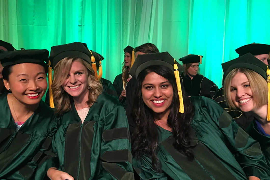 4 women in Master's graduation caps and gowns