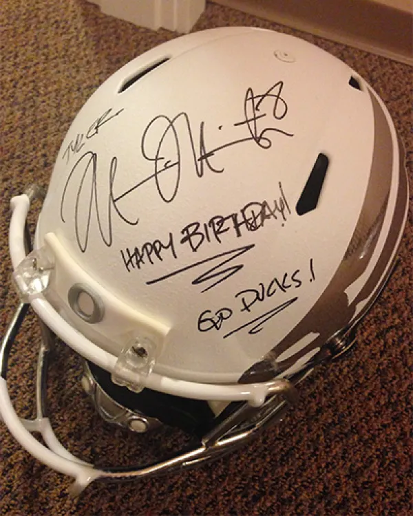 White Oregon football helmet with Marcus Mariota's signature, and a message saying "Happy birthday! Go Ducks!"