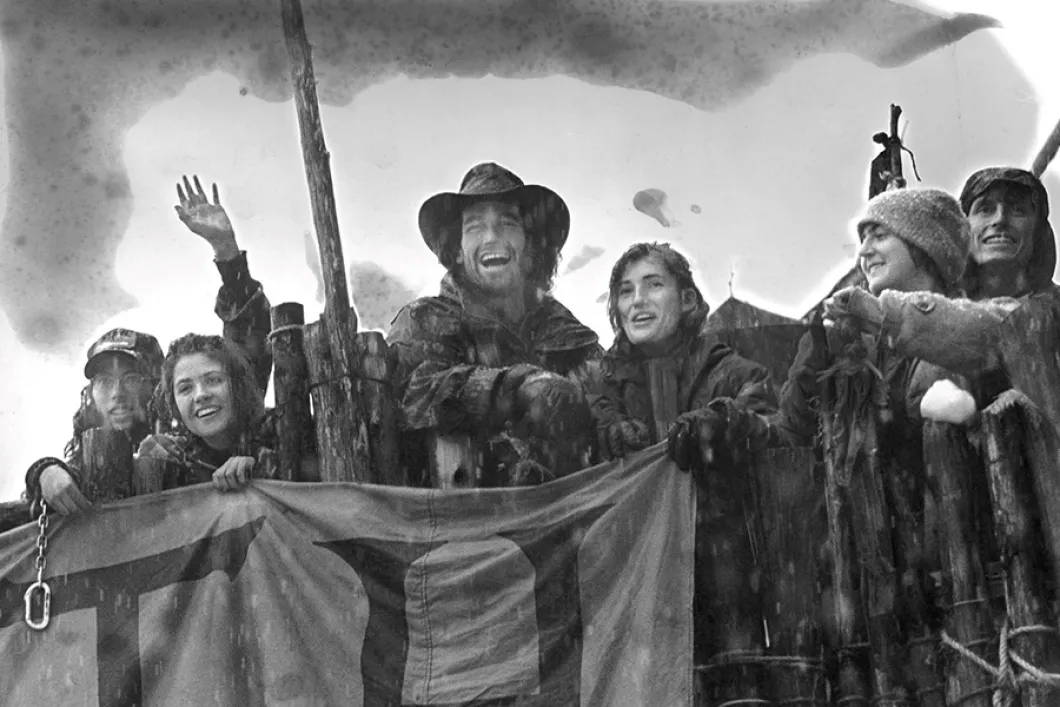 People standing with a flag in a blockade