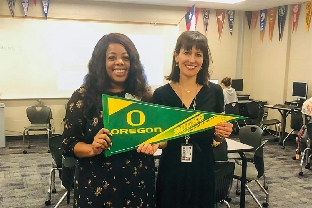 People holding a UO pennant
