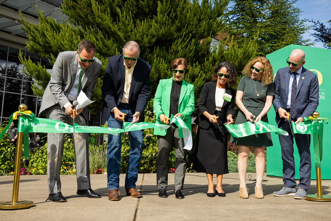 Various UO leadership members cutting the ribbon at the Portland Campus grand opening