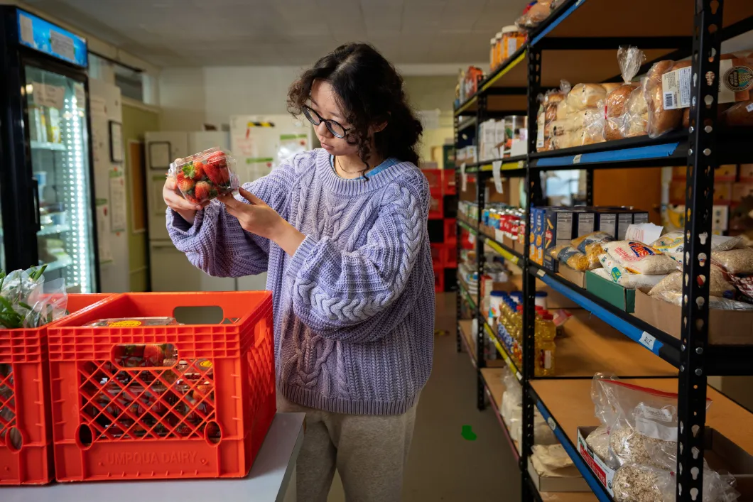 A student sorts items at the food pantry