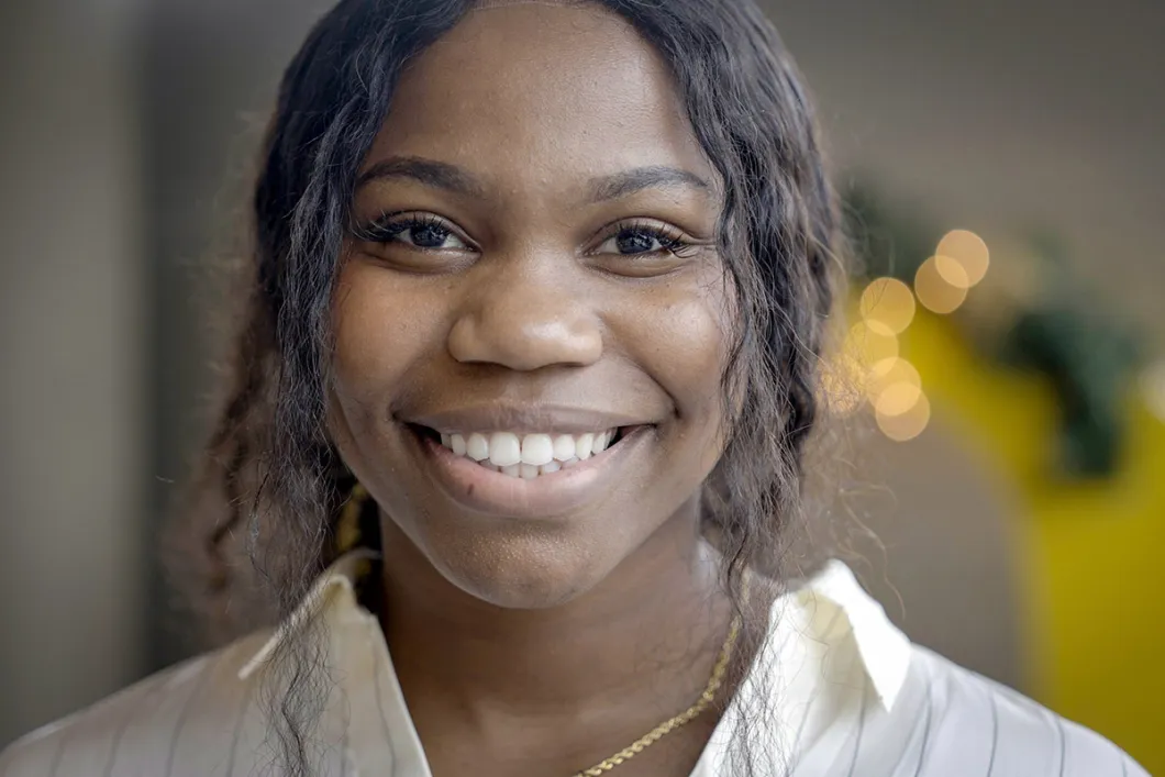 Headshot of Rhodes looking at the camera smiling