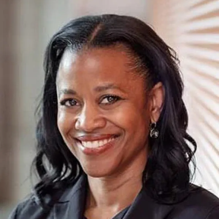 A smiling woman with shoulder length black hair. 