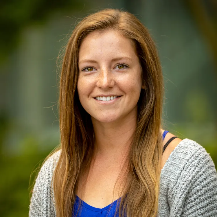 A smiling woman with long brown hair 