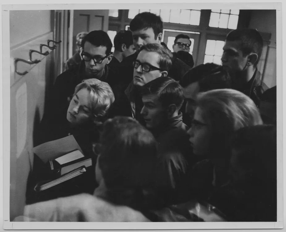 Students looking at test scores in a black and white photograph