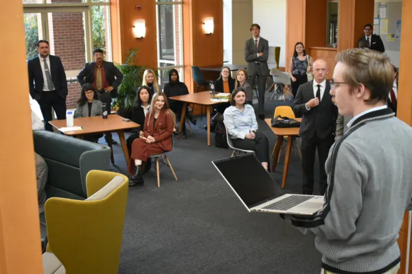 Law students looking and watching student speak.