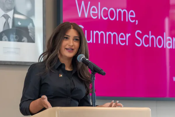 Sophia Barghouti standing at podium speaking into a microphone