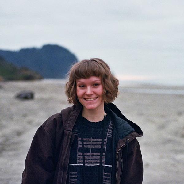 Student standing outside on a beach
