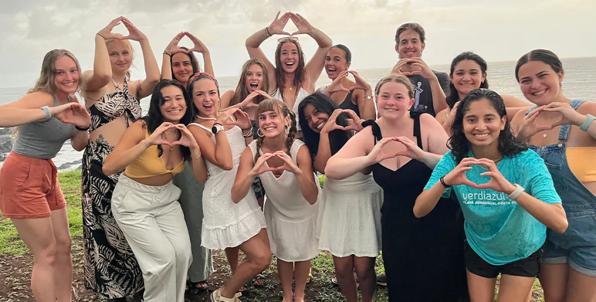 A group of students throwing the O hand symbol in Costa Rica