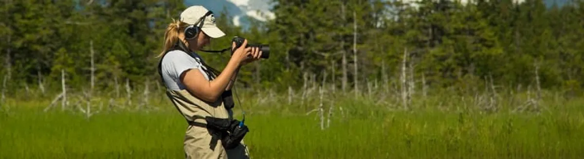 A student journalist taking photos in the field
