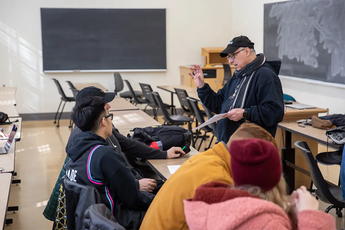 An instructor speaks to students in a classroom