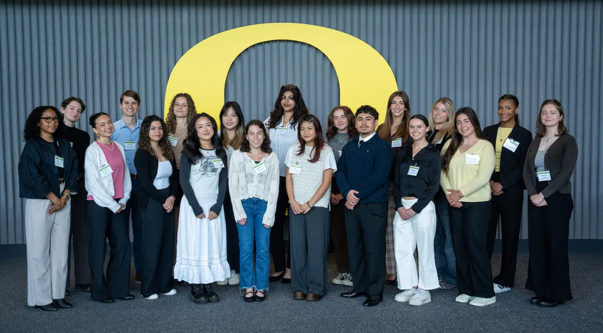 PIE participants gather in front of a yellow O. 
