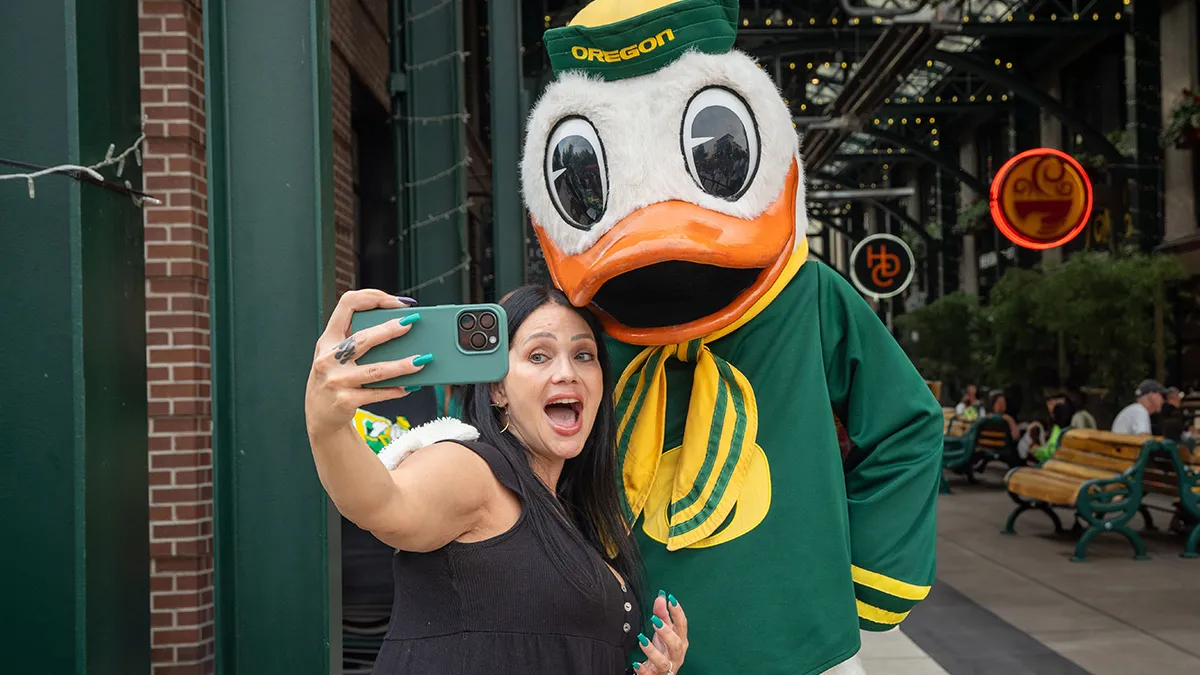 Woman taking a selfie with the Duck at 5th Street Market Alley