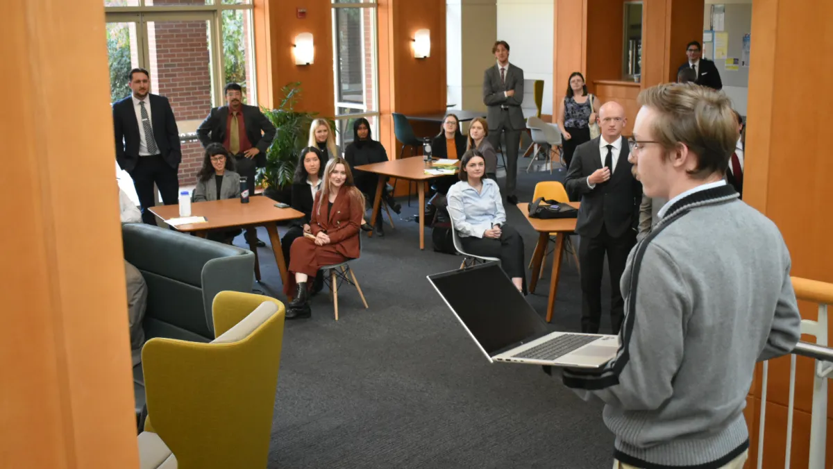 Law students looking and watching student speak.