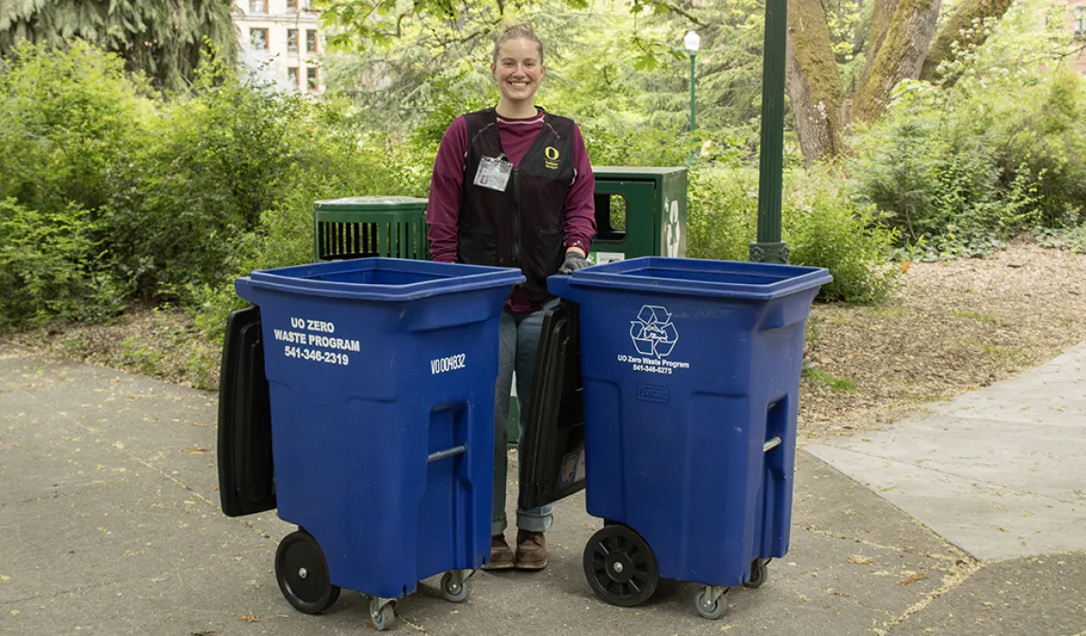 A person next to zero waste cans