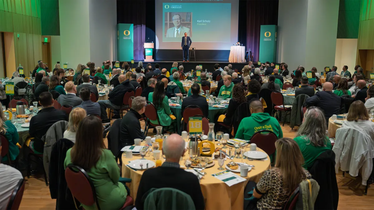 President Scholz speaks from the stage to an audience of alumni volunteers